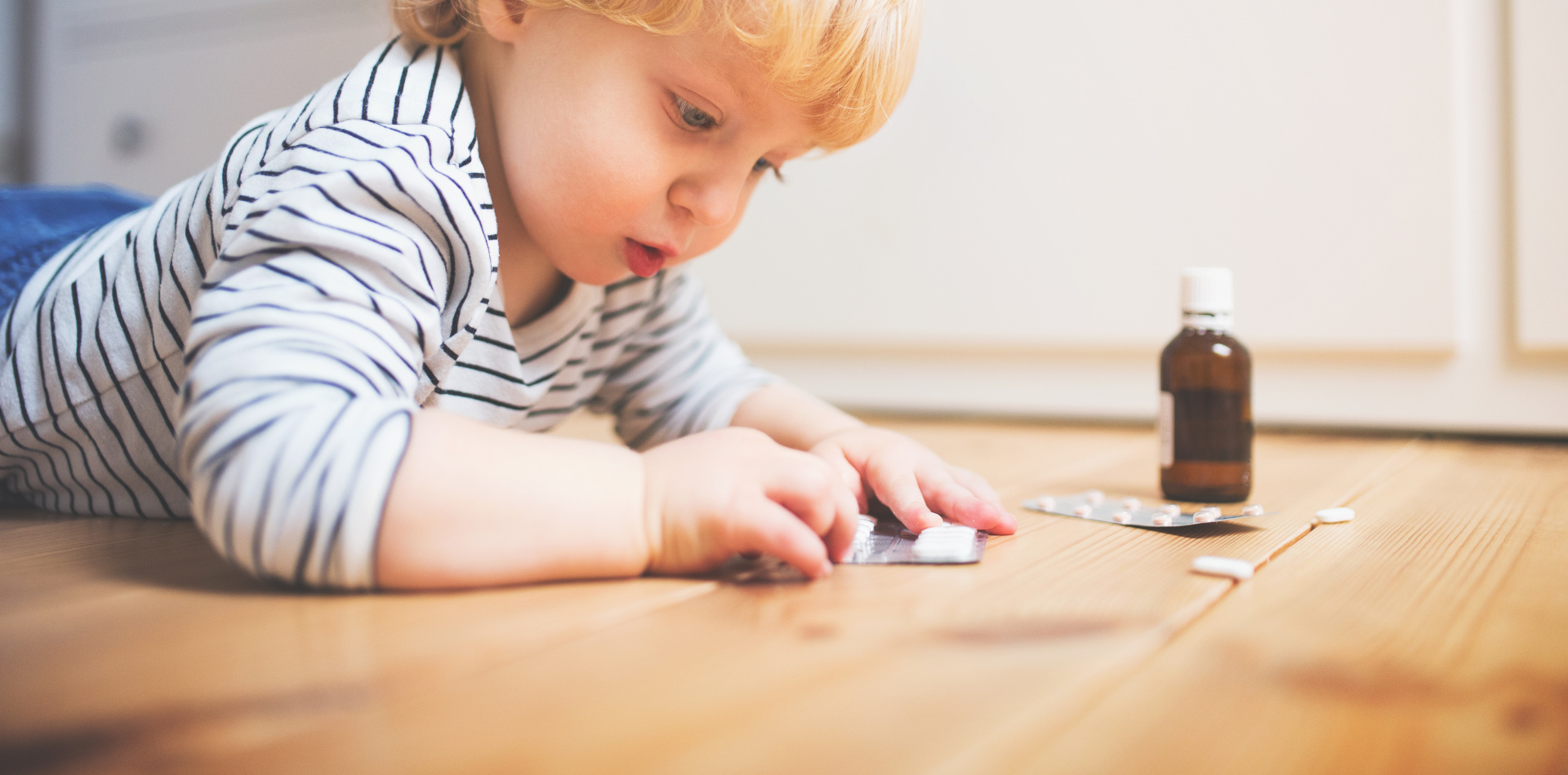 Little toddler playing with pills